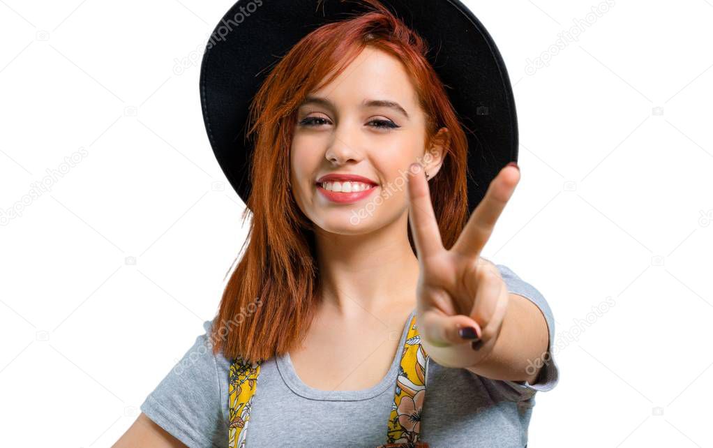 Cool redhead girl with hat celebrating a victory