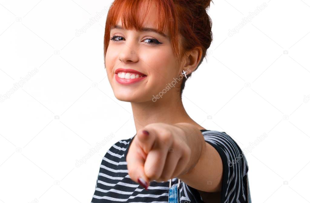 Young student redhead girl points finger at you