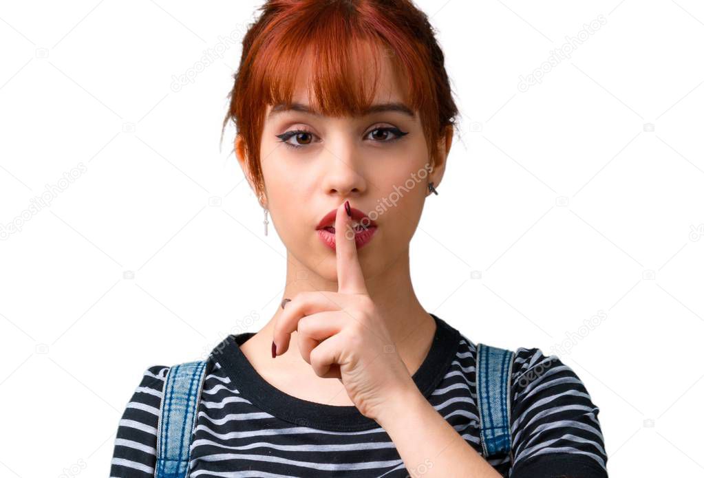 Young student redhead girl showing a sign of closing mouth and silence gesture