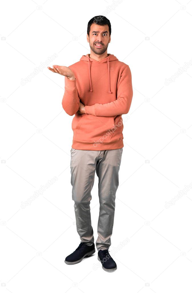 Full body of Man in a pink sweatshirt unhappy and frustrated with something. Negative facial expression on isolated white background
