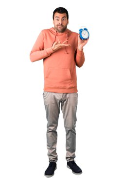 Adam tam vücut içinde izole beyaz arka plan üzerinde vintage çalar saat tutan bir pembe kazak