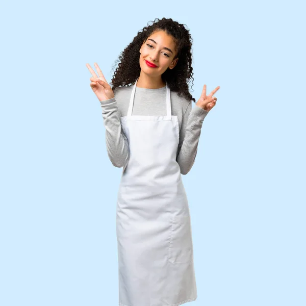 Young Girl Apron Smiling Showing Victory Sign Isolated Blue Background — Stock Photo, Image