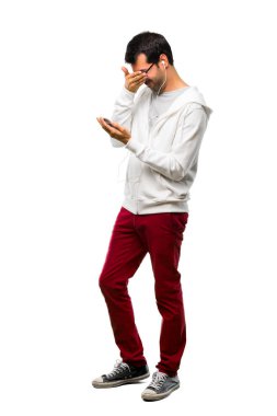 Bir adam gözlük ve müzik dinleme gözleri eller tarafından kapsayan tam uzunlukta bir kadeh. Beyaz arka plan üzerinde ileride ne gördüğüme şaşırdım