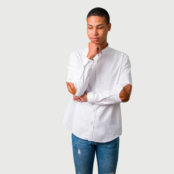 Young African American Man Standing Looking Hand Chin Grey Background — Stock Photo, Image