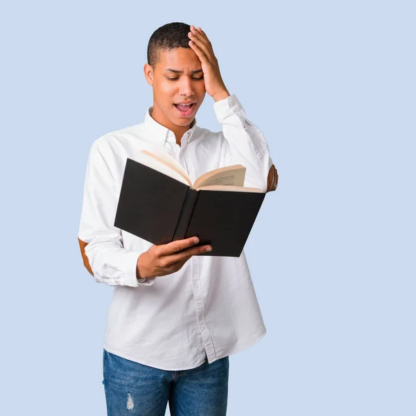 Young African American Man White Shirt Holding Book Surprised While — Stock Photo, Image