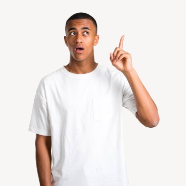 Ayakta ve izole arka plan üzerinde parmak işaret bir fikir düşünme genç Afro-Amerikan adam