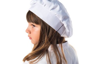 Küçük sevimli kız bir şef gibi giyinmiş