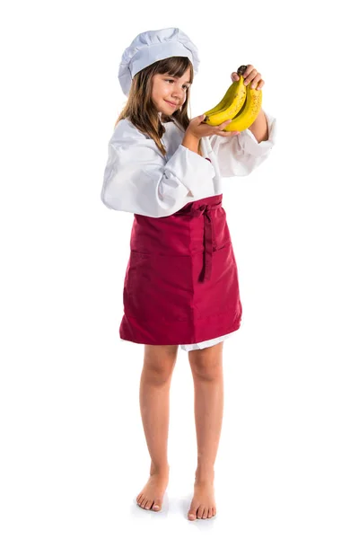 Piccola Ragazza Carina Vestita Come Uno Chef Che Tiene Banane — Foto Stock