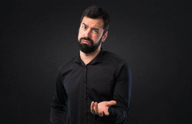 Siyah arka plan üzerine sakallı yorgun yakışıklı adam