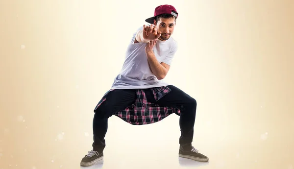 Man dancing street dance on ocher background