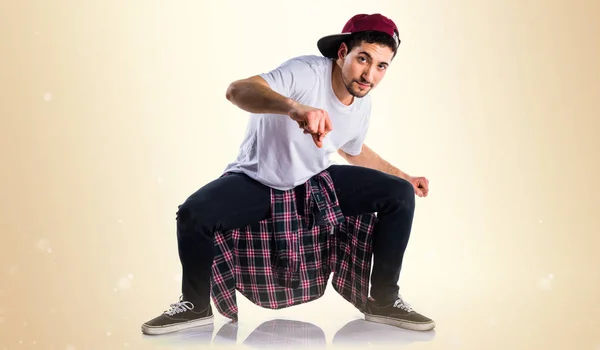 Man dancing street dance on ocher background