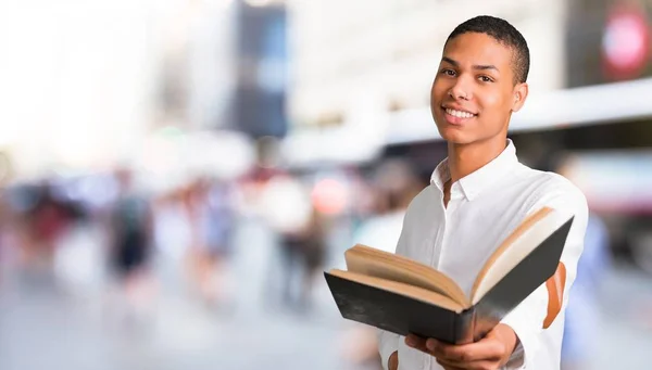 Young African American Man White Shirt Holding Book Giving Someone — Stock Photo, Image