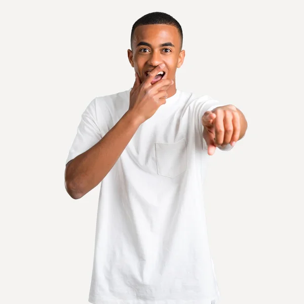 年轻的非洲裔美国男子指着手指在某人和笑了很多 而覆盖口在孤立的背景 — 图库照片