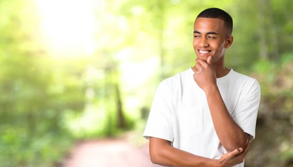 Young African American Man Standing Looking Side Hand Chin Park — Stock Photo, Image