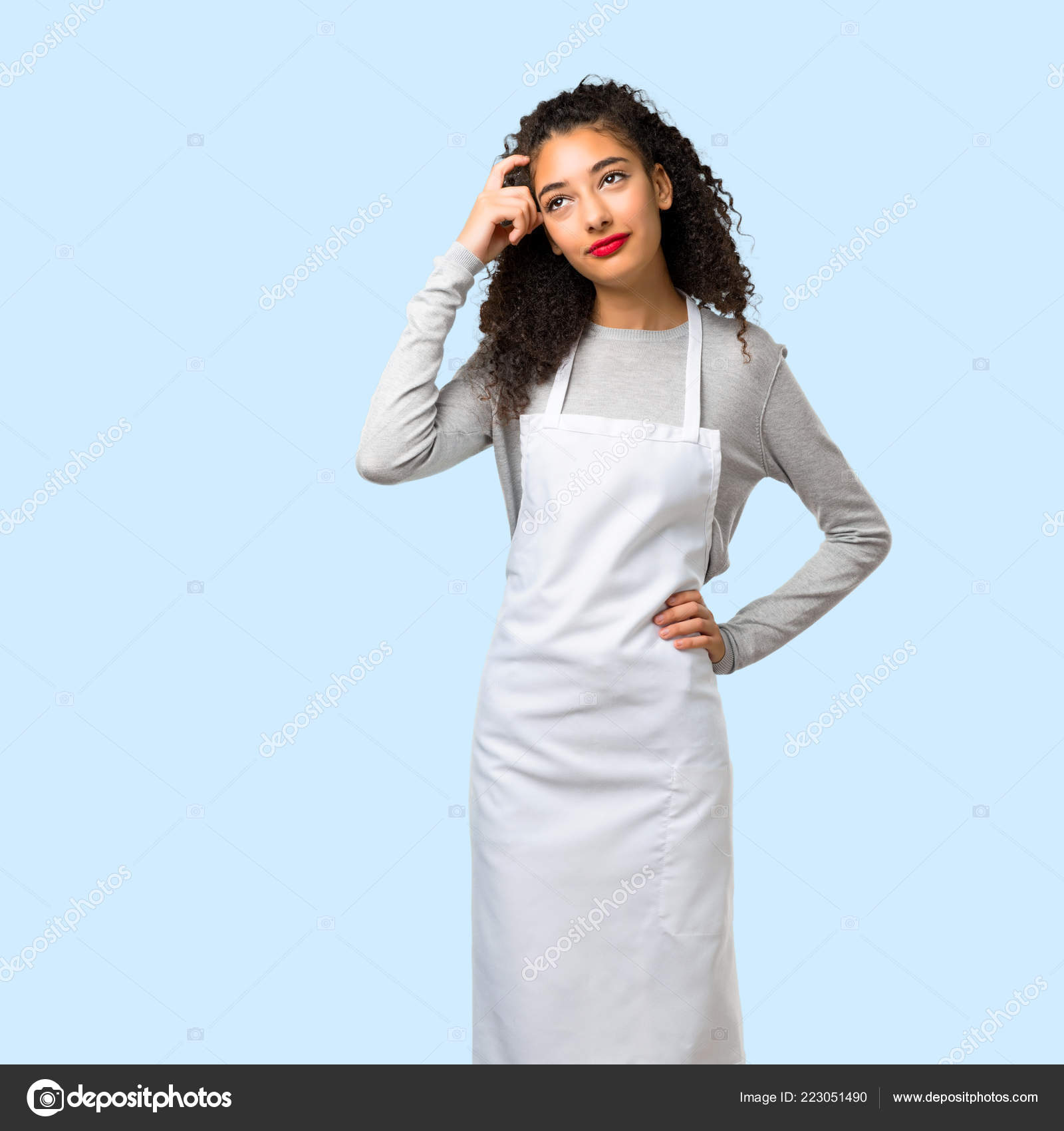 Young Girl Apron Standing Thinking Idea Isolated Blue Background Stock