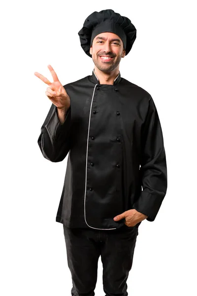 Chef Hombre Uniforme Negro Sonriendo Mostrando Signo Victoria Con Una — Foto de Stock