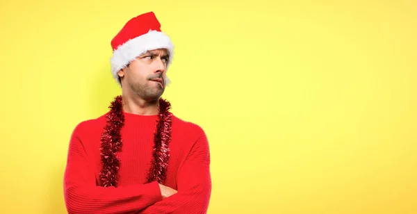 Man Red Clothes Celebrating Christmas Holidays Confuse Face Expression While — Stock Photo, Image