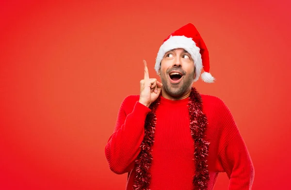 Man Red Clothes Celebrating Christmas Holidays Standing Thinking Idea Pointing — Stock Photo, Image