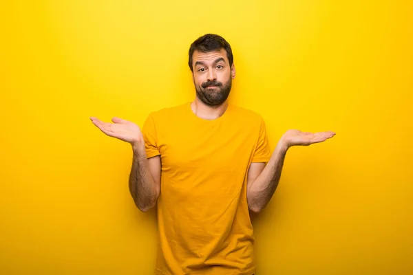 Man Isolated Vibrant Yellow Color Having Doubts While Raising Hands — Stock Photo, Image