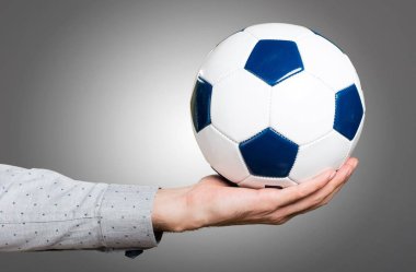 Bir futbol topu tutan adamın elini