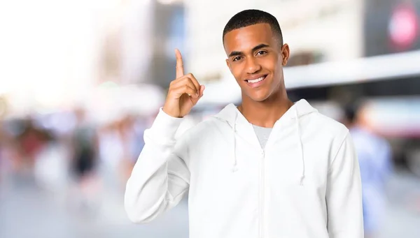 Dark Skinned Young Man White Sweatshirt Showing Lifting Finger Sign — Stock Photo, Image