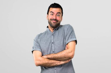 Silah tutmak yakışıklı adam gri arka plan üzerinde çarpı işareti