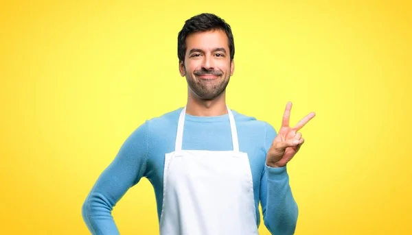 Man Wearing Apron Smiling Showing Victory Sign Cheerful Face Yellow — Stock Photo, Image