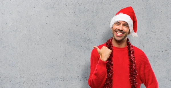 Man Red Clothes Celebrating Christmas Holidays Pointing Side Finger Present — Stock Photo, Image