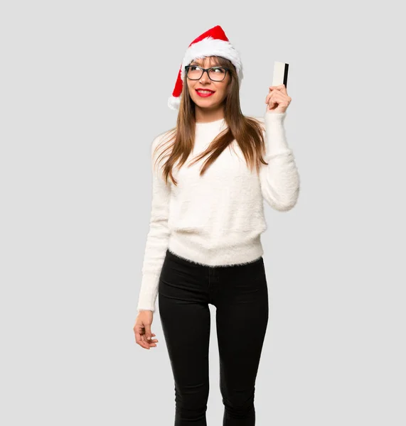 Girl Celebrating Christmas Holidays Holding Credit Card Thinking Isolated Grey — Stock Photo, Image