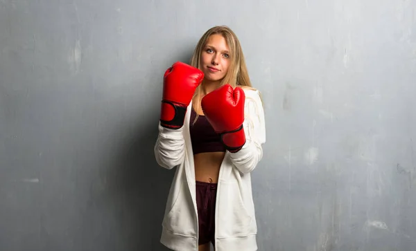 Young sport woman with boxing gloves