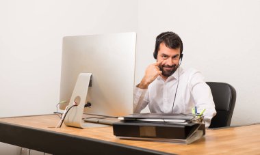 Telemarketer adam önüne bakarak bir ofiste