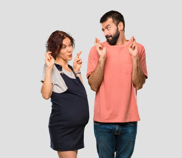 Couple Pregnant Woman Fingers Crossing Wishing Best Isolated Grey Background — Stock Photo, Image