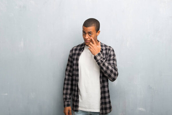 Young african american man with checkered shirt looking to the front