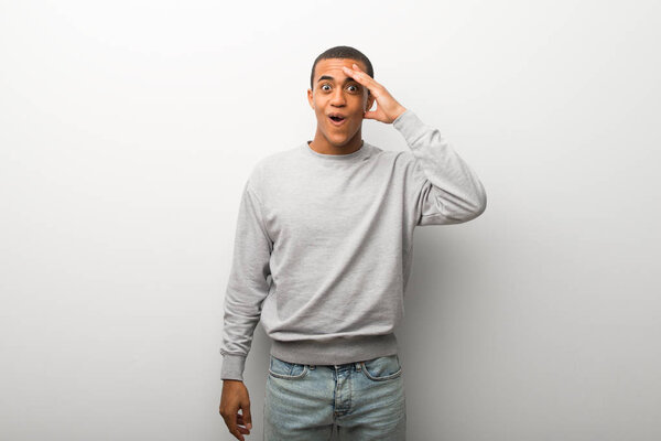 African american man on white wall background has just realized something and has intending the solution