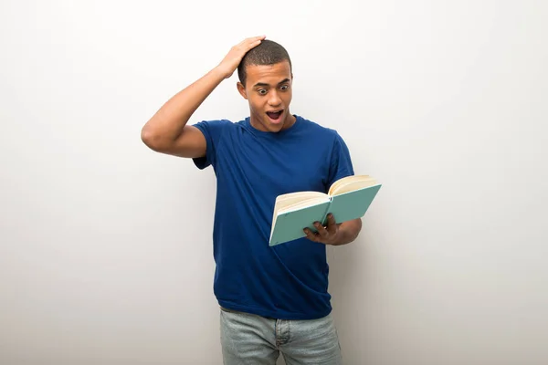 Young African American Man White Wall Surprised While Enjoying Reading — Stock Photo, Image