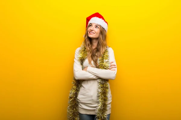 Menina Comemorando Feriados Natal Fundo Amarelo Olhando Para Cima Enquanto — Fotografia de Stock