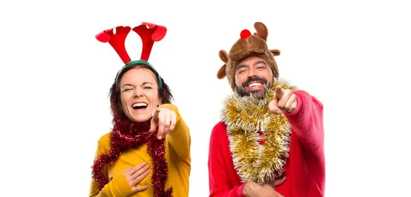 Couple Dressed Christmas Holidays Pointing Finger Someone Laughing Lot Isolated — Stock Photo, Image