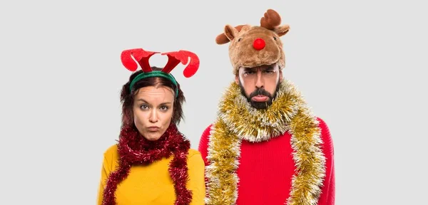 Couple Dressed Christmas Holidays Sad Depressed Expression Serious Gesture Isolated — Stock Photo, Image