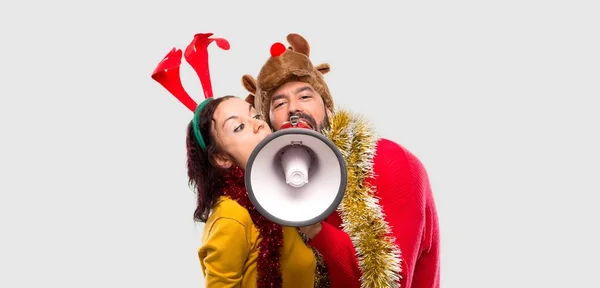 Couple Dressed Christmas Holidays Holding Megaphone Isolated Background — Stock Photo, Image