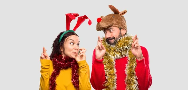 Couple Dressed Christmas Holidays Fingers Crossing Wishing Best Isolated Background — Stock Photo, Image