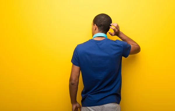 African American Man Blue Shirt Yellow Background Back Position Looking — Stock Photo, Image