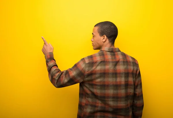 Jonge Afro Amerikaanse Man Levendige Gele Achtergrond Terug Met Wijsvinger — Stockfoto