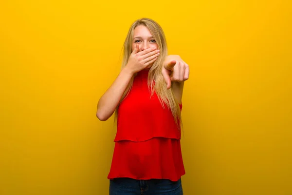 Young Girl Red Dress Yellow Wall Pointing Finger Someone Laughing — Stock Photo, Image