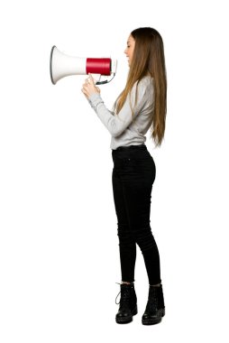 Lateral pozisyonda izole beyaz arka planda bir şey duyurmaktan bir megafon ile bağırarak genç kızın tam uzunlukta atış
