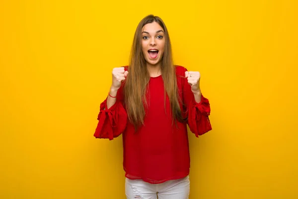 Young Girl Red Dress Yellow Wall Celebrating Victory Winner Position — Stock Photo, Image