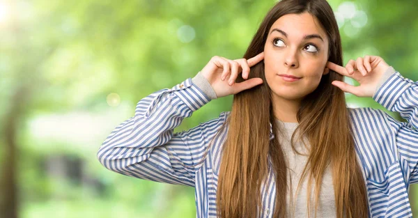 Young Girl Striped Shirt Covering Both Ears Hands Outdoors — Stock Photo, Image