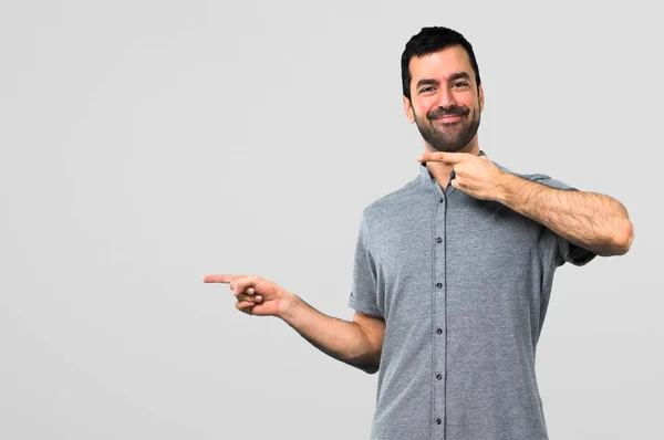Handsome Man Pointing Finger Side Presenting Product Grey Background — Stock Photo, Image