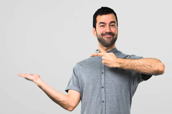 Handsome Man Holding Copyspace Imaginary Palm Grey Background — Stock Photo, Image