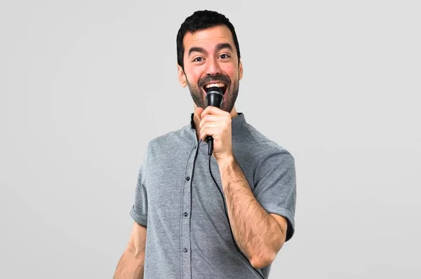 Handsome Man Singing Microphone Grey Background — Stock Photo, Image
