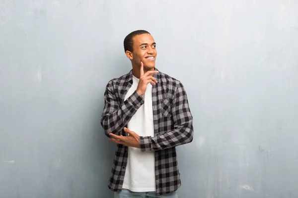 Giovane Uomo Afroamericano Con Camicia Scacchi Pensando Idea Mentre Alza — Foto Stock